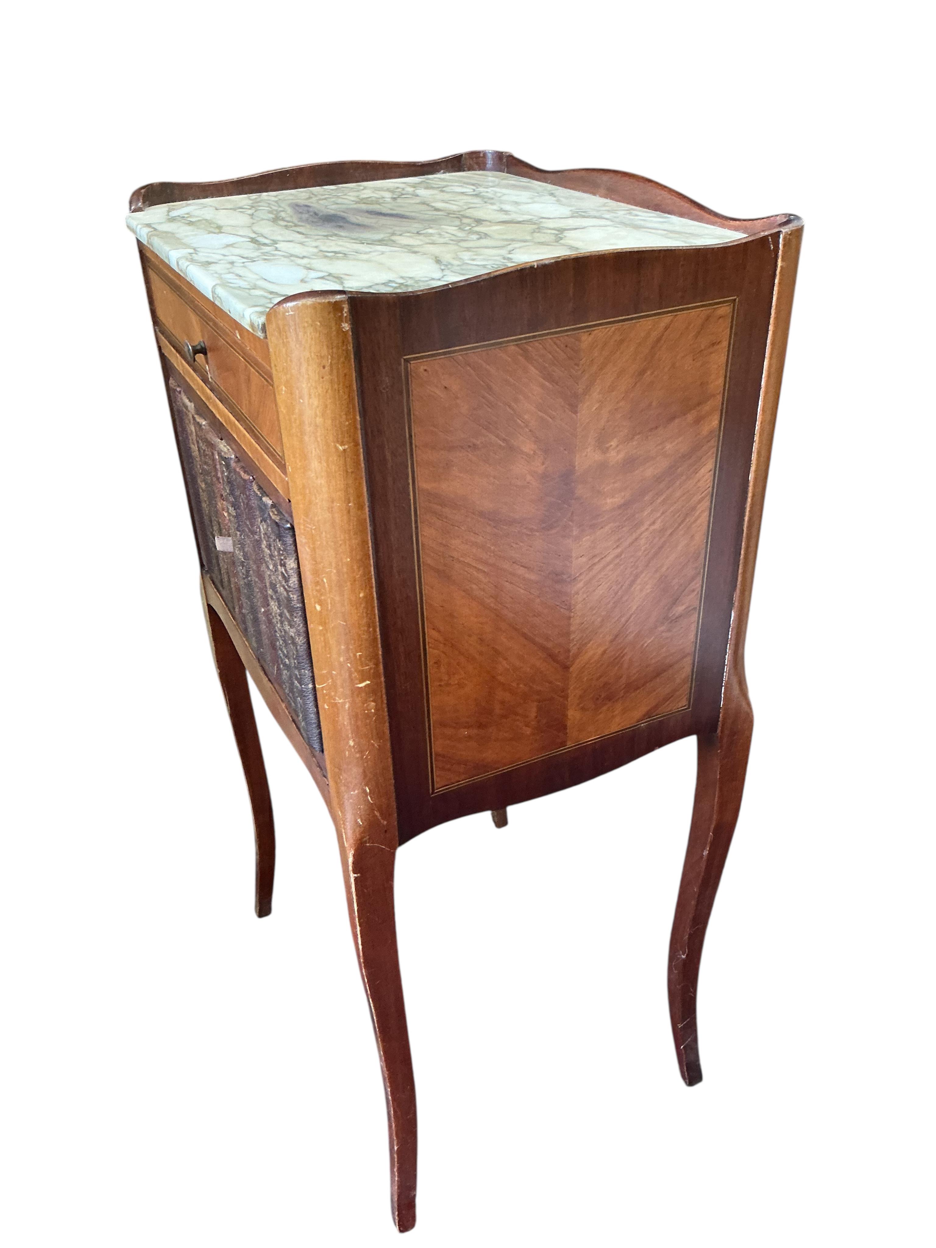A pair of French marble topped kingswood bedside cabinets with faux book spine doors, width 39cm, depth 30cm, height 74cm